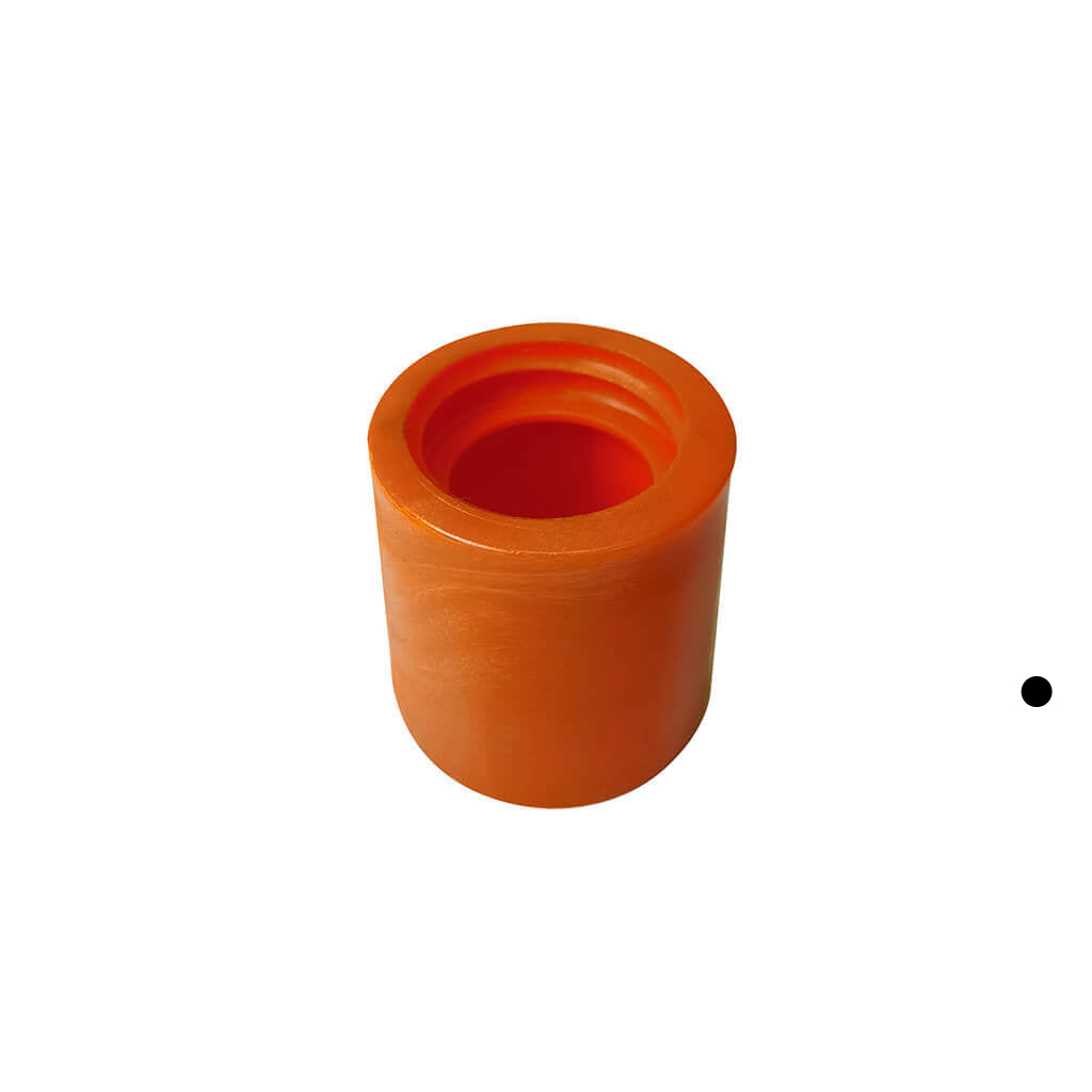 An orange cylindrical plastic component with a hollow center, shown on a plain white background with a small black dot to the right.
