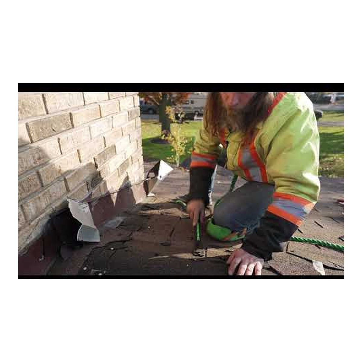 Roofer using the Primegrip Clawverine on an asphalt shingle roof