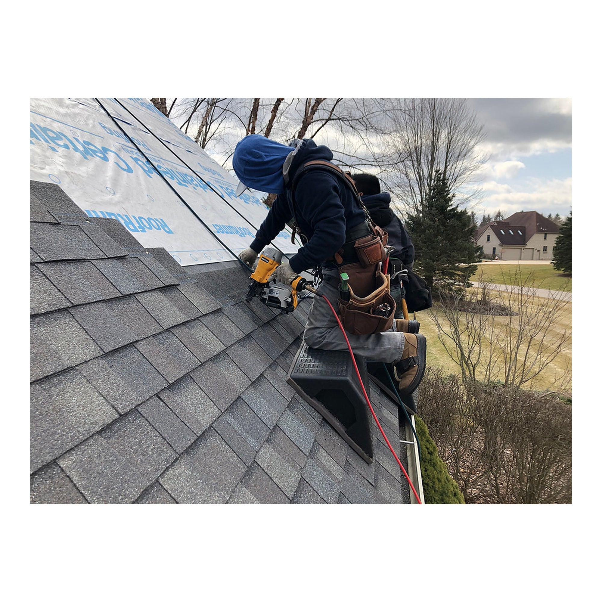 Primegrip 32 in. Pitch Hopper providing a temporary work surface near a roof ladder