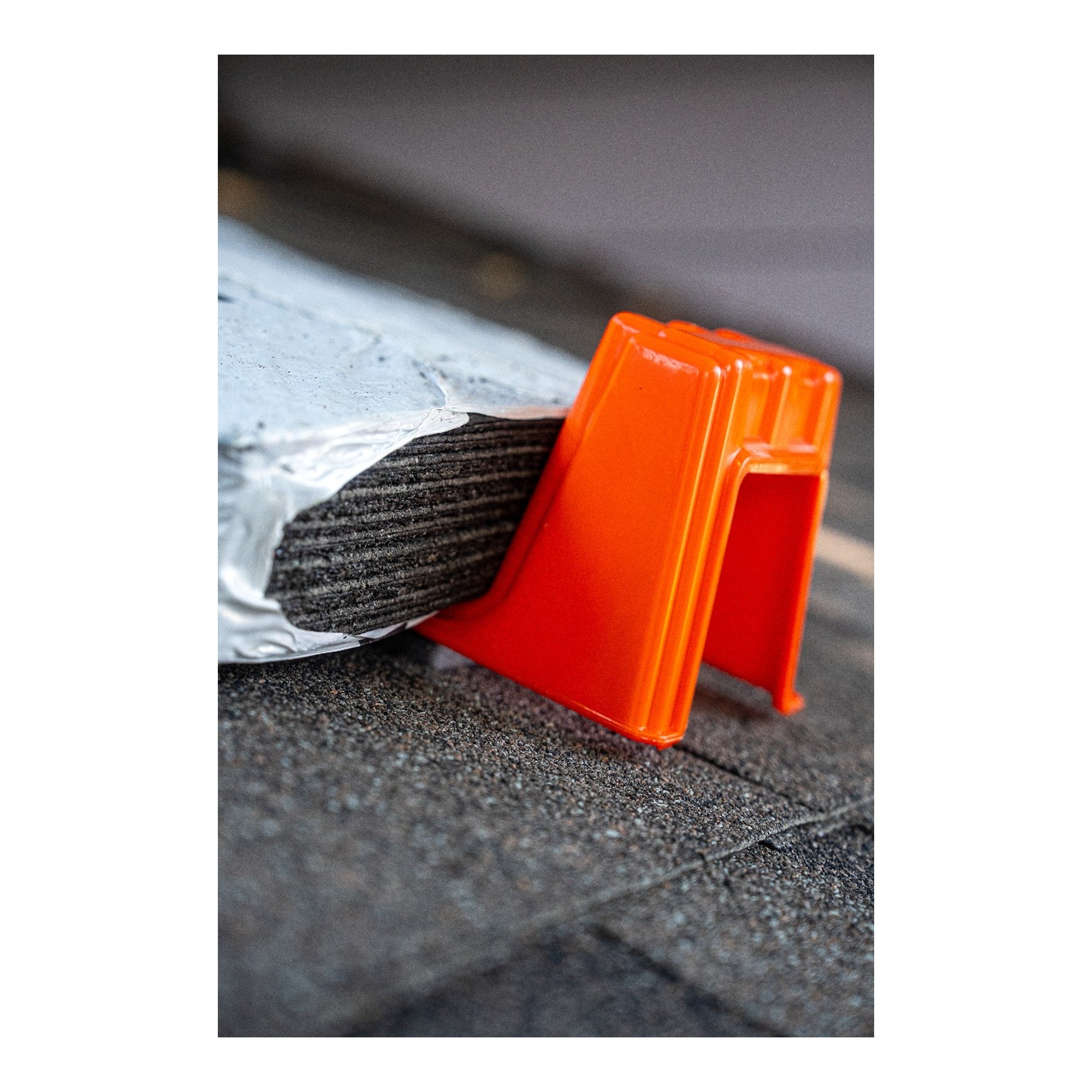 Primegrip BMF Shingle Anchor installed beneath a shingle bundle